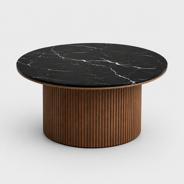Round coffee table with black marble top and wooden base on a white background